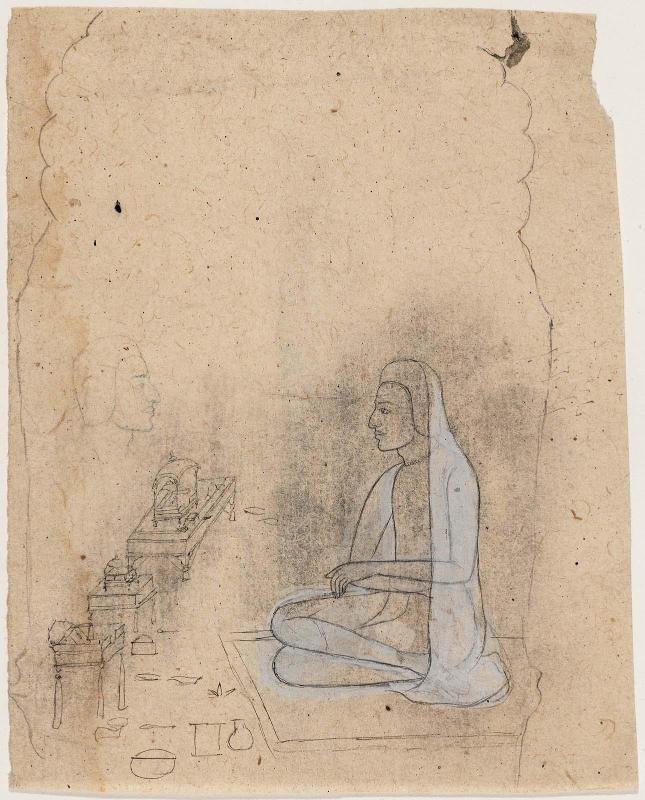 Two pujaris, one performing a ritual