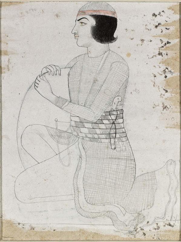 Young man kneeling with a shield